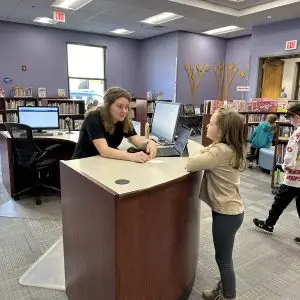 kid asking question at information desk